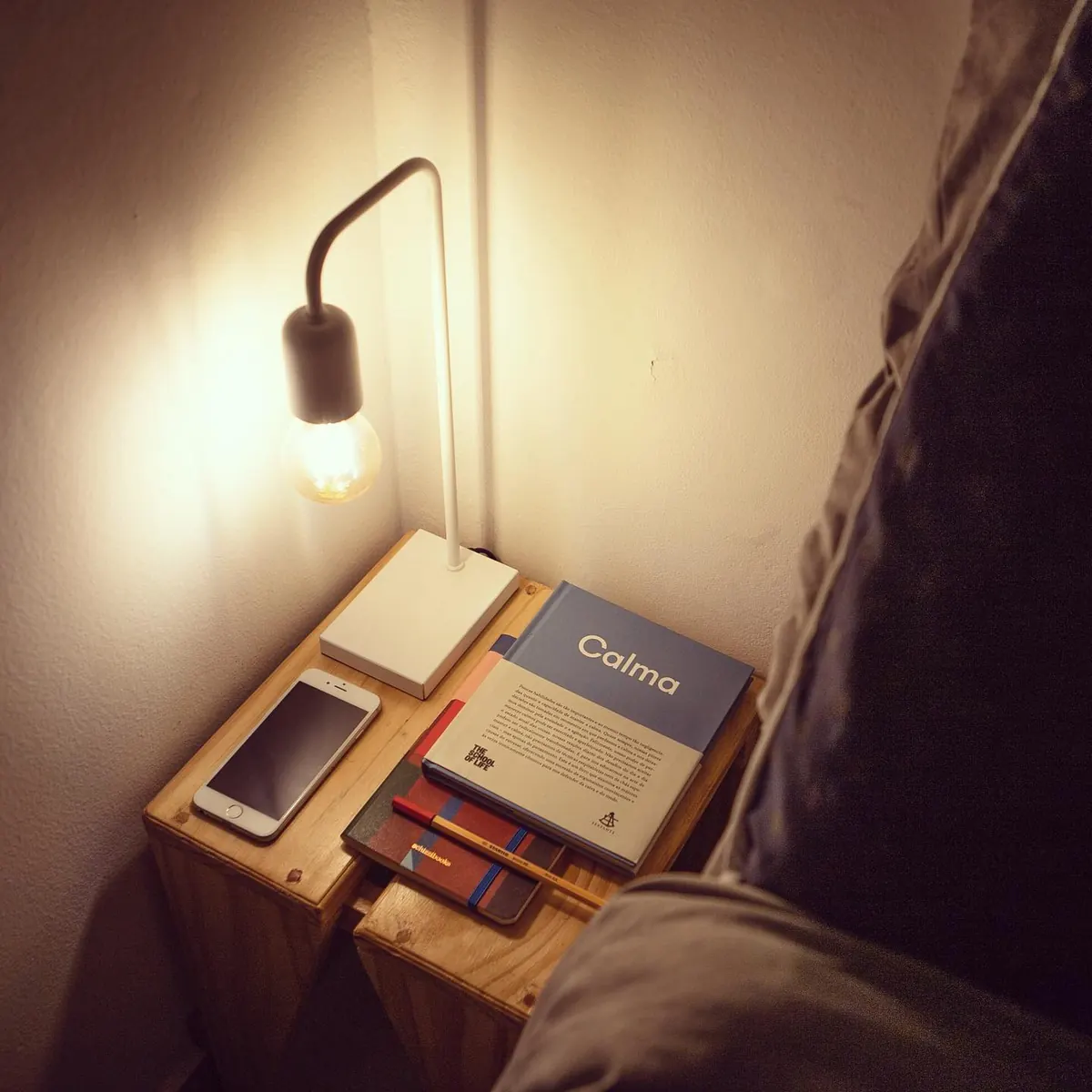 Luminária acesa ao lado da cama no apartamento 403